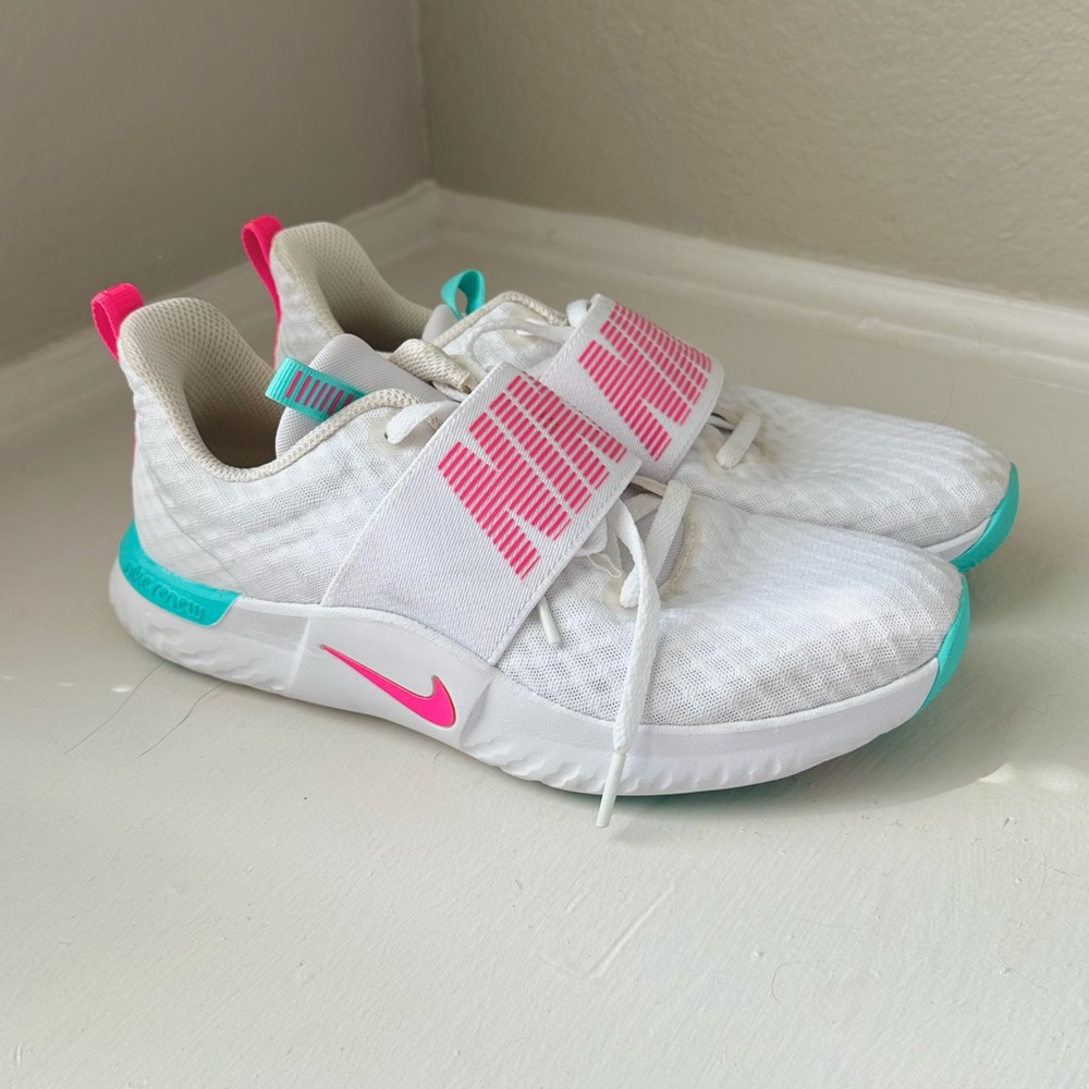 White/pink/teal Nike athletic shoes